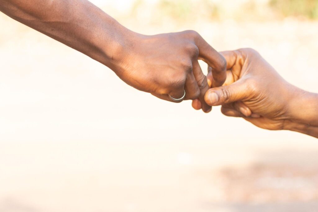 two people holding each other's hands in trust